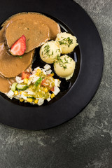 Pork meat with sauce, potatoes and salad, restaurant serving portion