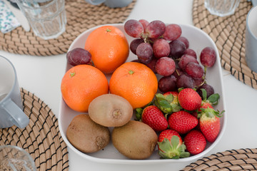 Naklejka na ściany i meble Fresh mixed tropical fruits on plate for breakfast