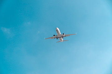 Fototapeta na wymiar Travel by plane, aviation concept. Airliner in blue sky