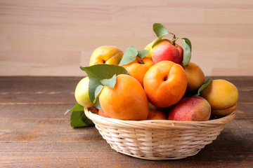 A lot of fresh, ripe apricot in a bag on a brown wooden background