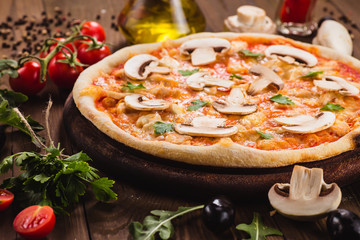 italian pizza with chicken and mushrooms on the wooden dark background (close).