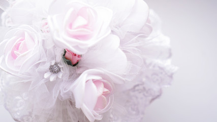 Wedding bouquet made of white roses on a blurred white background