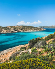 Naklejka na ściany i meble Islands with clear turquoise water in Mediterranean sea. Nature summer seascape in Malta. Travel and tourism in summer time concept. Malta, Comino Island