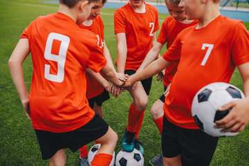 Kids on Football Soccer Team Putting Hands in. Boys Football School Team Huddling. Children Hands...