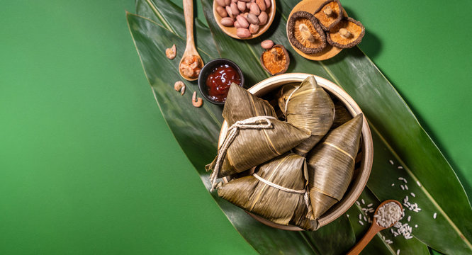 Zongzi, Steamed Rice Dumplings On Green Table Background, Food In Dragon Boat Festival Duanwu Concept, Close Up, Copy Space, Top View, Flat Lay