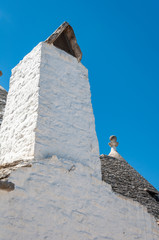 Fototapeta na wymiar Alberobello, Italy. The picturesque village of trulli. Stone houses built in the typical circular shape with cone roofs.