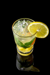 Alcoholic or non-alcoholic cocktail with lemon, lime and cucumber with the addition of liquor, vodka, champagne or martini. Cool drink isolated on black background. Cocktail card for a bar