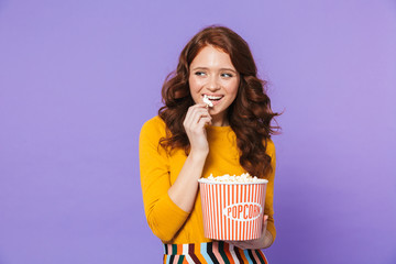 Portrait of a pretty young redheaded woman standing
