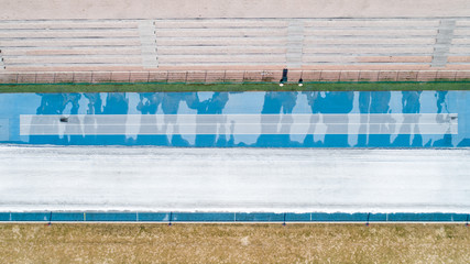 An aerial image of a blue race track from above.