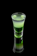 Green mexican. Alcoholic cocktails in shot glasses (shooters).  Cool drink from strong vodka, whiskey and sweet liqueurs isolated on black background. Cocktail card for a bar or restaurant.