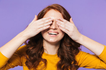 Portrait of a pretty young redheaded woman standing