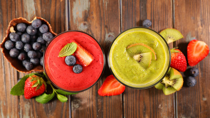 fruit juice, smoothie and ingredient on wood background