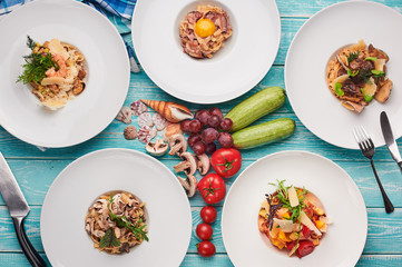 set of pasta at blue wooden background. italian cuisine flat lay. Gourmet food. Delicious restaurant dishes