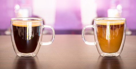 Black and white coffee in cups on the table