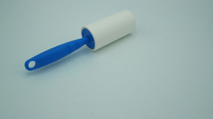 Lint roller  to clean dust on cloths isolated on white background.