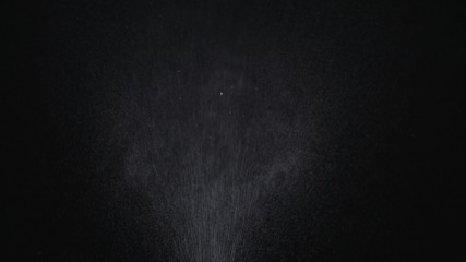 White exploding powder over black background