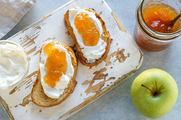 Toasted whole wheat bread with apple jam, ricotta (cream cheese)
