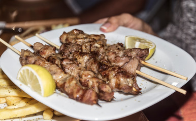 souvlaki greek etnic food mear roasted in a plate with lemon