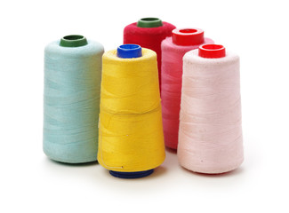 spools of thread for the textile industry on white background