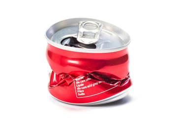 A red empty broken aluminum can at the white background, a close up.