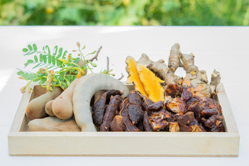 Turmeric and tamarind in a wooden tray. Ingredients for skin treatment.