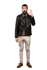 Fototapeta premium Handsome man with beard surprised and showing ok sign over isolated white background