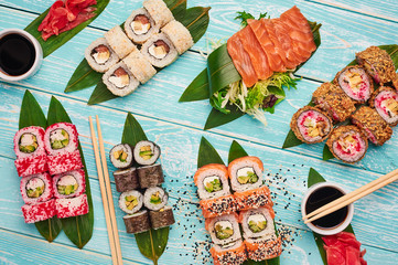 sushi roll set . sushi, sashimi, maki flat lay at blue wooden backdrop. japan cuisine.