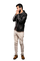 Naklejka premium Handsome man with beard covering mouth and looking to the side over isolated white background