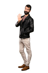 Handsome man with beard counting five with fingers over isolated white background