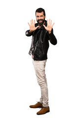 Naklejka premium Handsome man with beard counting ten with fingers over isolated white background