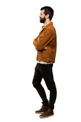 Naklejka premium Handsome man with beard in lateral position over isolated white background