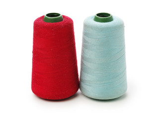 spools of thread for the textile industry on white background