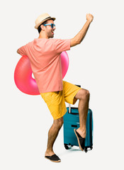 Full body of Man with hat and sunglasses on his summer vacation