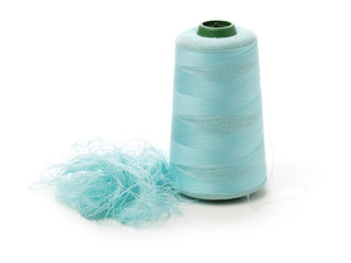 spools of thread for the textile industry on white background