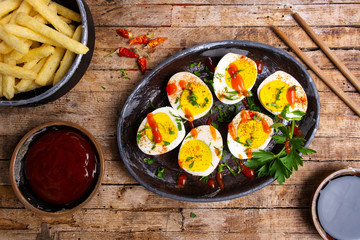Boiled eggs and french fires on a table