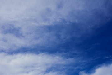 Naklejka na ściany i meble A deep blue sky with light white clouds background