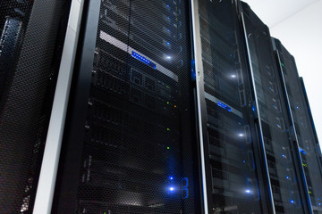 Server room interior in datacenter in blue light.
