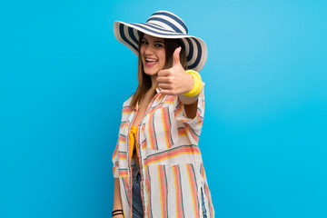 Young woman in bikini in summer holidays with thumbs up because something good has happened