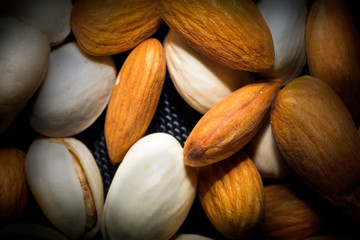 Almonds, Pistachios, Cashews mixed together on black background, it's Healthy Mix.