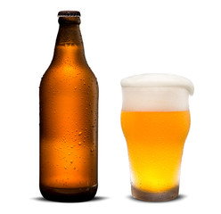 Glass of beer and Brown bottle with drops isolated on a white background