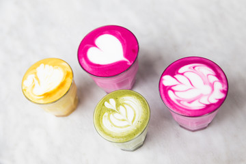 Glasses of beetroot, matcha,turmeric latte on marble table background. Trendy healthy drinks.