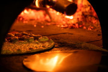 Italian pizza inside a wood oven