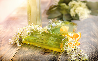 Refreshment healthy juice of elderberry flowers and orange on rustic board, alternative medicine...
