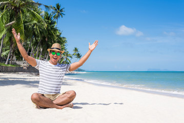 Happy young asian man on beach in vacation time.