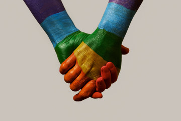 hands patterned with the rainbow flag