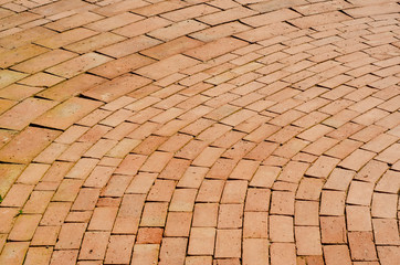 The red brick walkway is arranged in a row with a background patterned background.