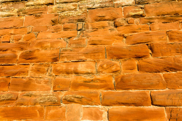 Background, sandstone brick wall lit by setting sun
