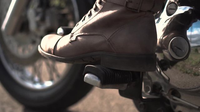 a man on a motorcycle shifts gears