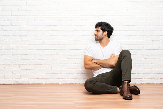 Young man sitting on the floor in lateral position