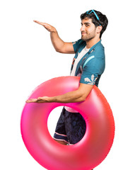 Man in trunks holding copyspace to insert an ad over isolated white background